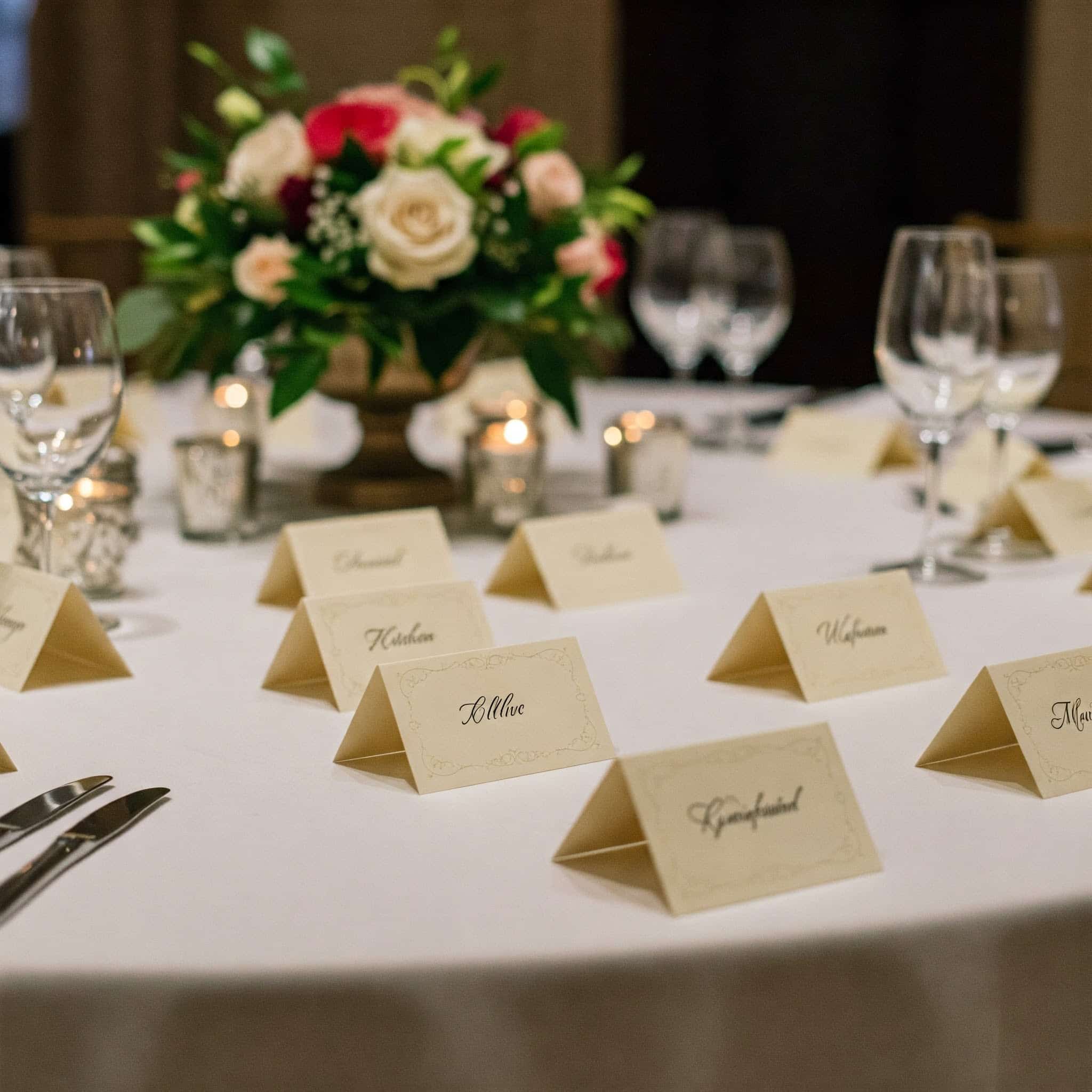 White scored card place cards folded and standing on a table